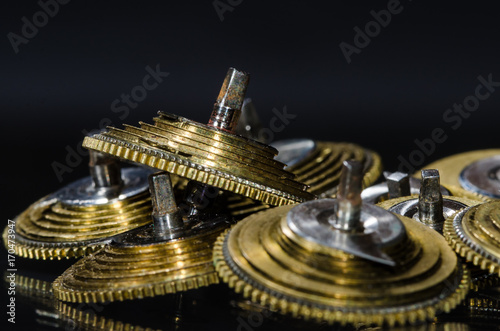 Watch Repair: Vintage Pocket Watch Fusee Cones Resting on a Black Surface