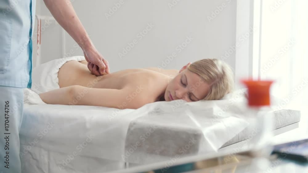 Beauty young woman is given a massage. Tibetan Medicine Beauty young woman is given a massage. Tibetan Medicine