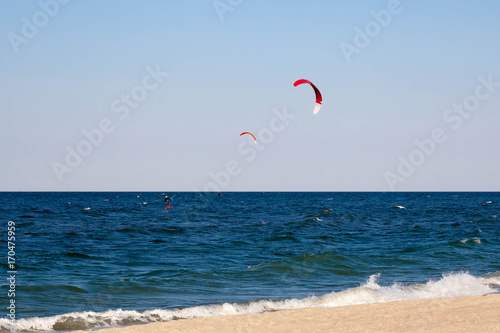 Kitesurfing background concept, two kitesurfers at the sea ocean