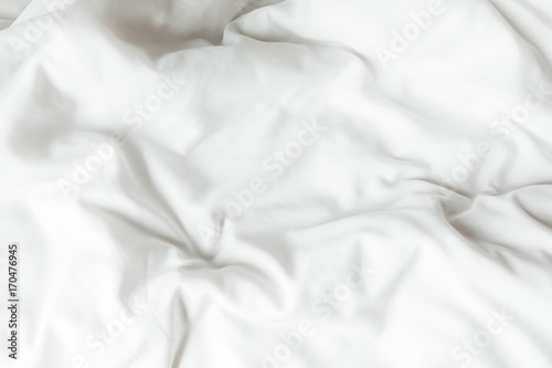 Top view of white bedding sheets after wake up in the morning