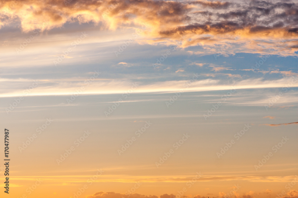 Beautiful colorful sunset skies. Dramatic skyline at dawn. Fiery splashes on the clouds. Natural background with the copy space.
