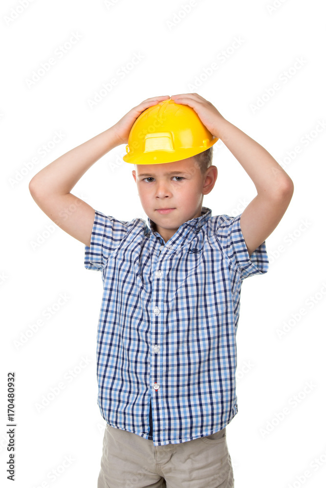 Adorable serious future builder in yellow helmet and blue checkred shirt, isolated on white background Adorable serious future builder in yellow helmet and blue checkred shirt, isolated on white background