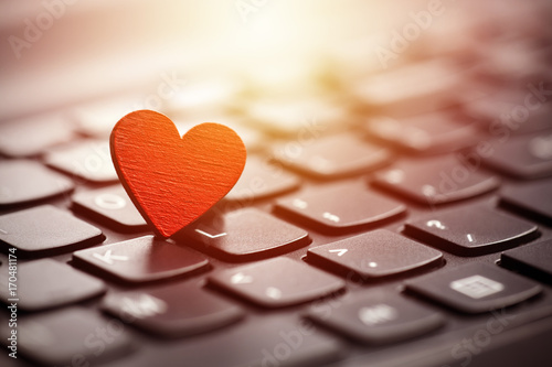 Konstfotografi Small red heart on keyboard. Internet dating concept.