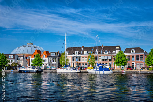 Boats and houses on Spaarne river. Haarlem, Netherlands © Dmitry Rukhlenko