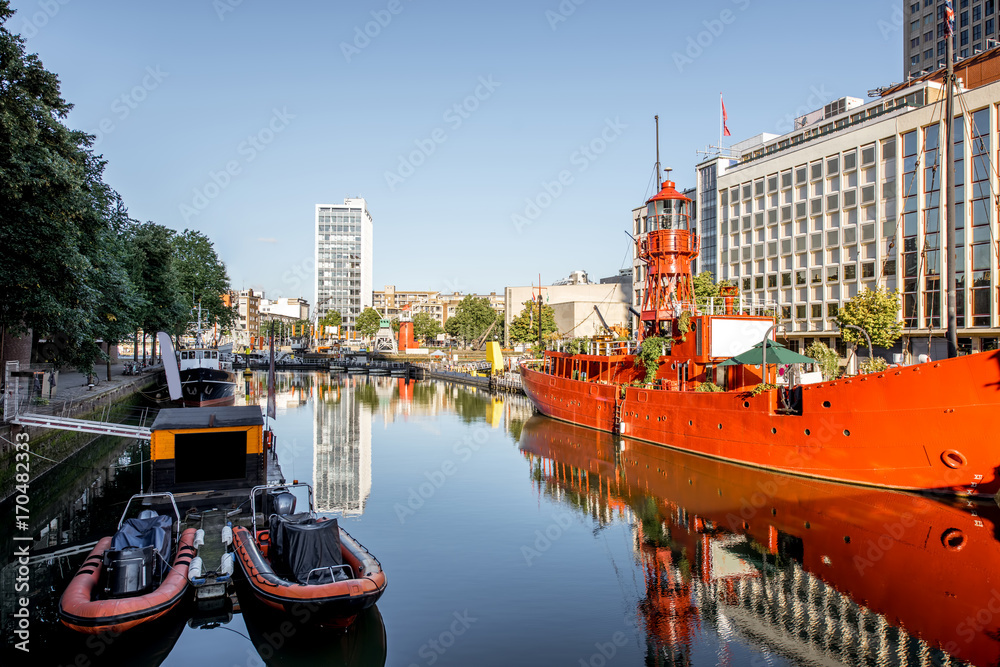 Morning view on the Wijn port with red ship in Rotterdam city