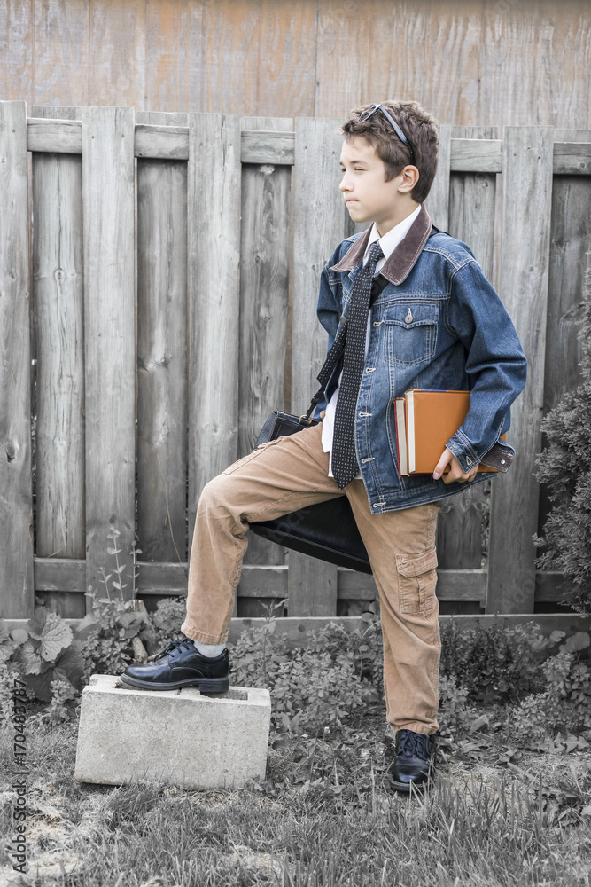 Trendy preteen boy posing in vintage style denim and corduroy