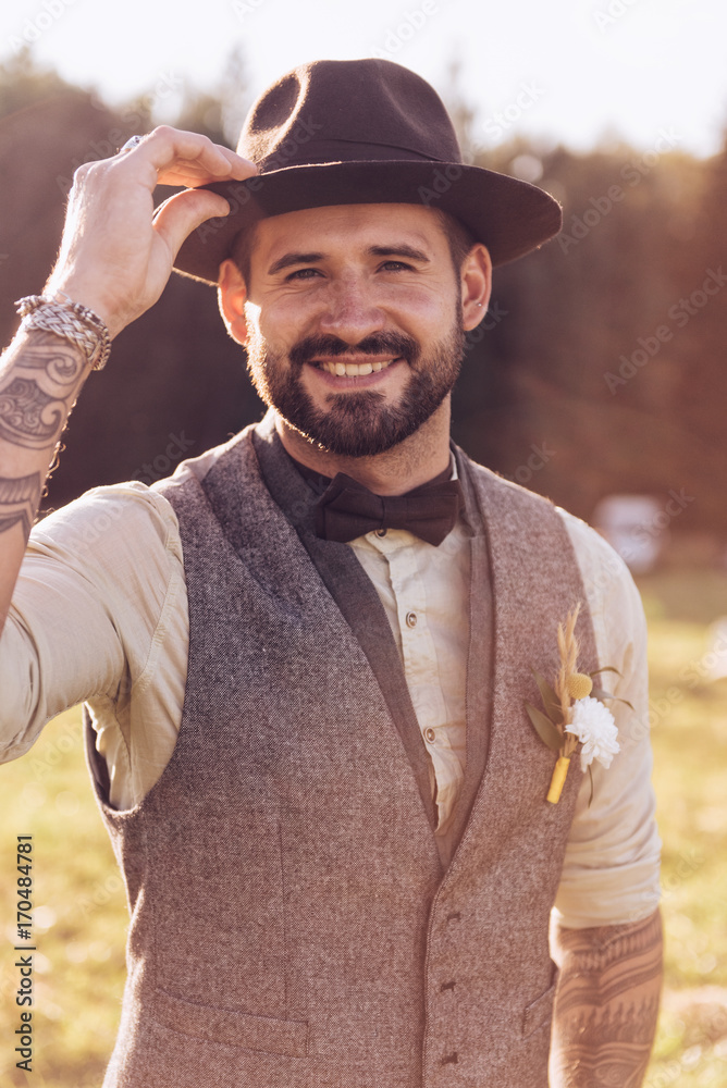 Obraz premium Portrait of stylish beard, male with tattoos on his arms. Wedding portrait