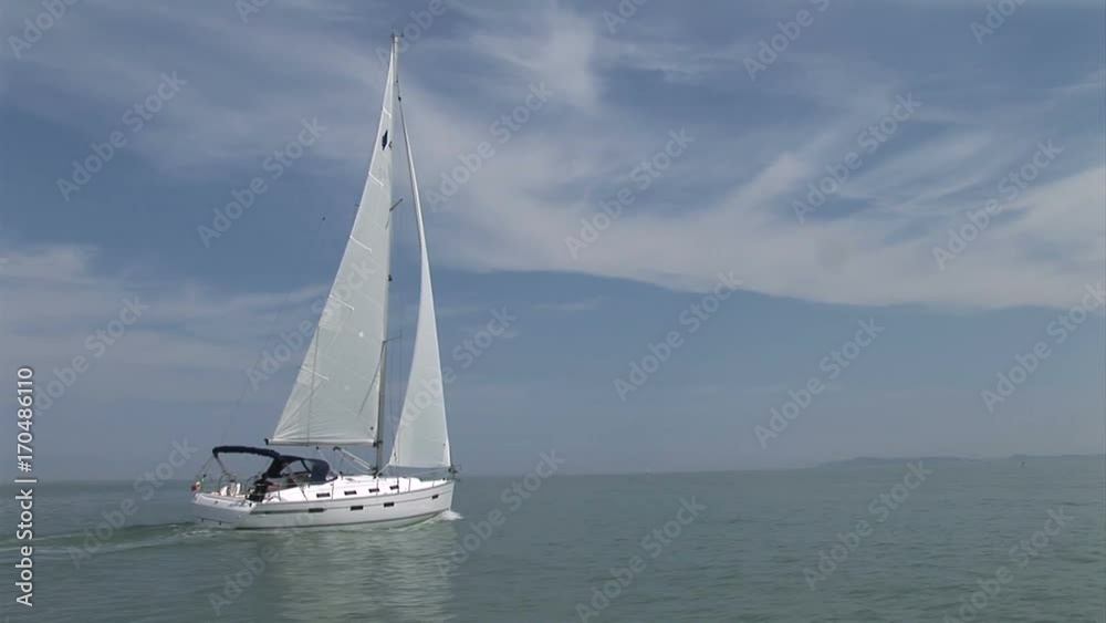 Sailing boat navigating in the sea with open sails. Sailing boat navigating in the sea with open sails.