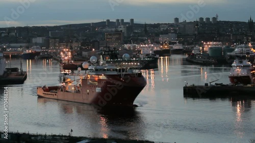 Oil rig support vessel leaving Aberdeen Harbour at dusk