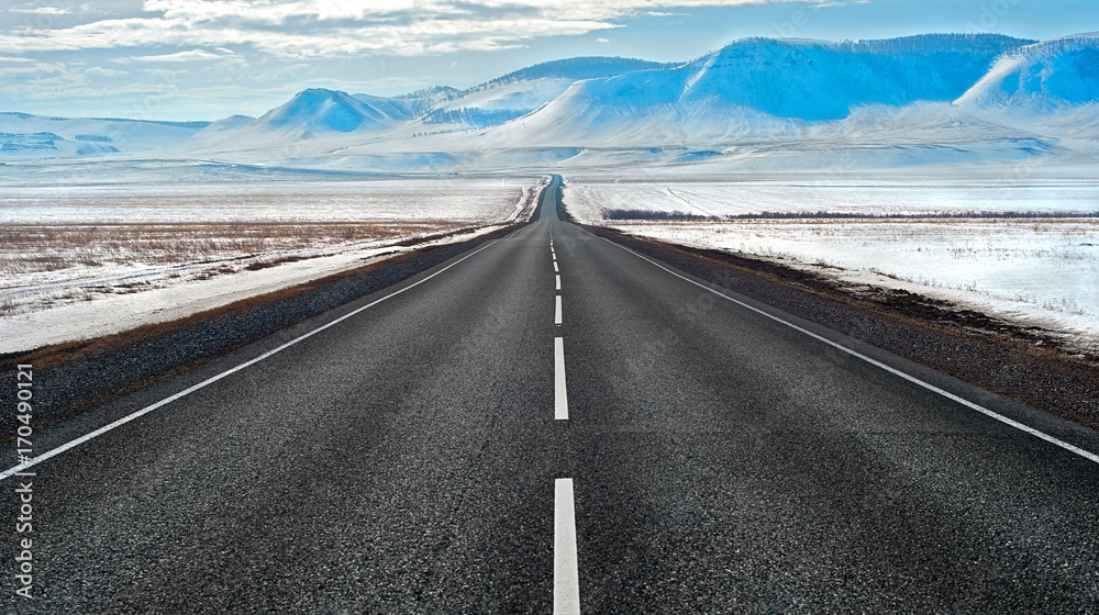 Fototapeta premium Highway route in Siberia to the snowy mountains