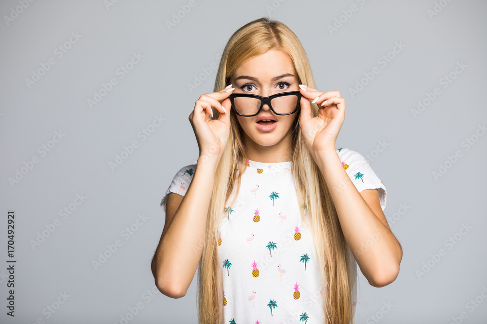 Closeup portrait beautiful happy young woman with glasses take down shocked isolated on grey green background wall. Closeup portrait beautiful happy young woman with glasses take down shocked isolated on grey green background wall.