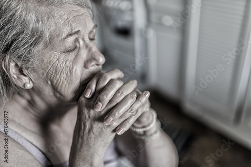 Praying senior woman. You are never truly alone if you have faith