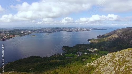 Woman is hiking on the top of a mountain in Norway, aerial view photo