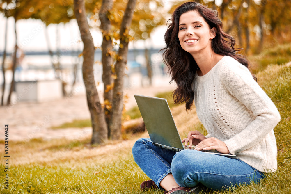 Young woman with laptop outdoors. Young woman with laptop outdoors.