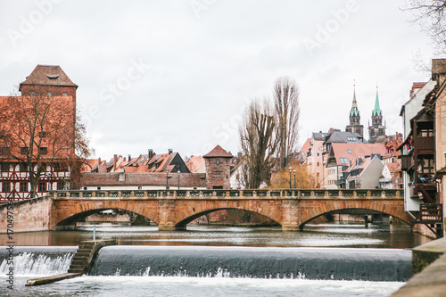 View of the pedestrian bridge and various buildings and houses in winter in Nuremberg in Germany. City view.
