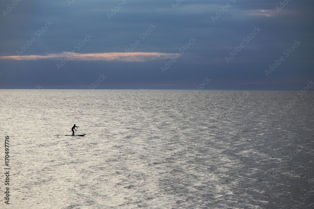SUP surfer at sea
