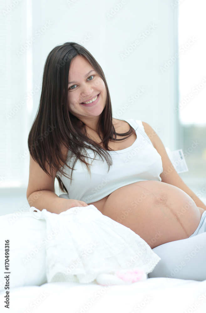 Pregnant woman relaxing at home on the couch Pregnant woman relaxing at home on the couch
