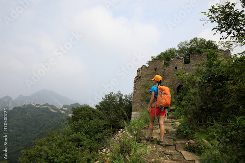 young woman hiker hiking on great wall