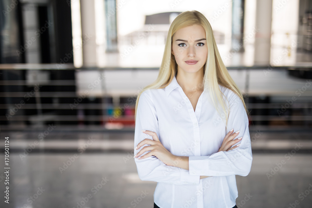 Fototapeta premium Portrait of a young confident business woman in an office