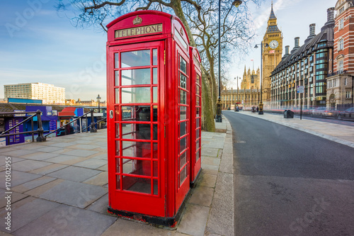 London, England - Traditional British red telephone box at Victoria Embankment with Big Ben at background © zgphotography