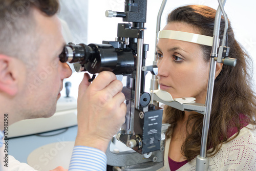 optometrist examining female patient in ophthalmology clinic