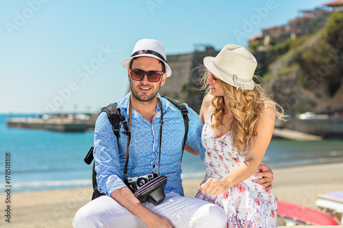 Happy tourists resting at the doc while exploring the city together. © FS-Stock