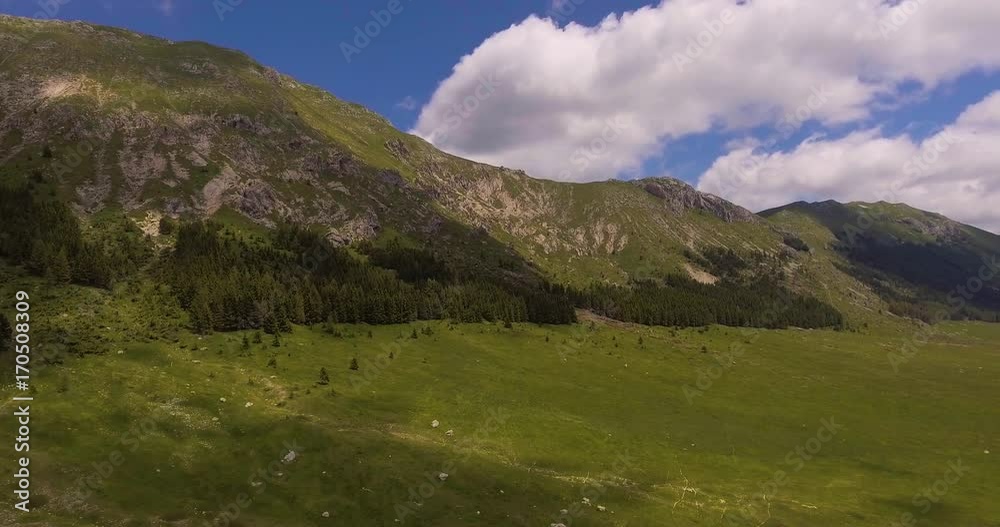 Aerial, green mountains and huge meadow on plateau in summer in Italy, 4K Aerial, green mountains and huge meadow on plateau in summer in Italy, 4K