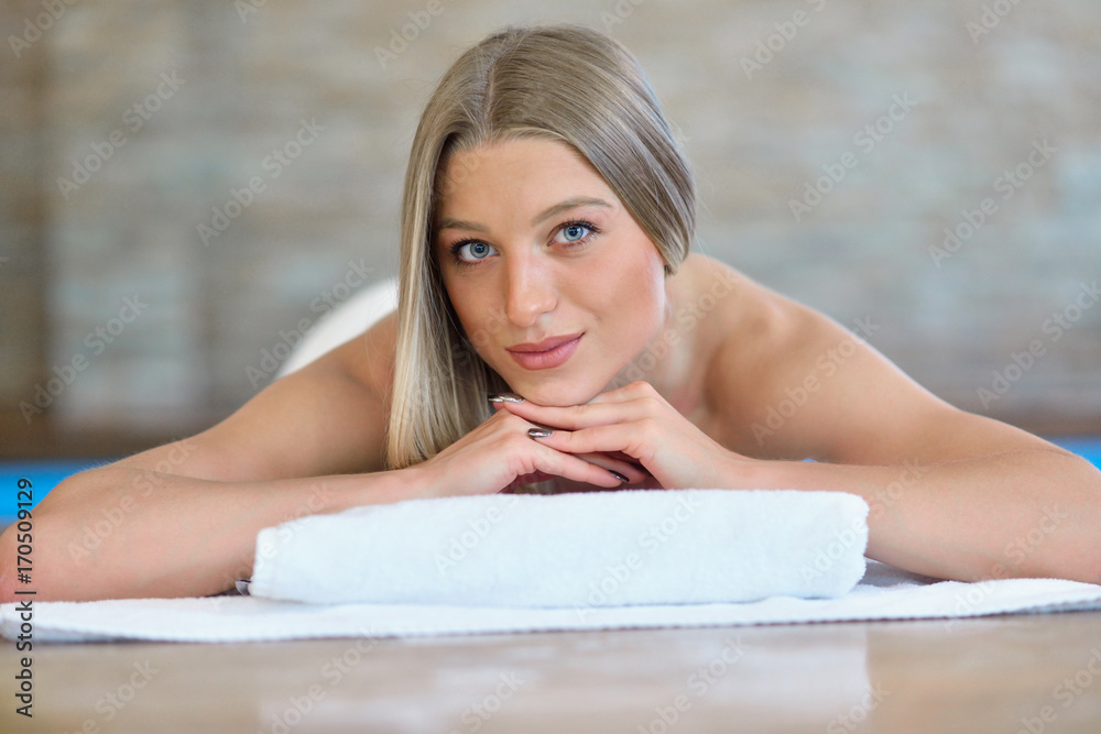 Beautiful woman relaxing in spa salon with hot stones on body. Beauty treatment therapy Beautiful woman relaxing in spa salon with hot stones on body. Beauty treatment therapy
