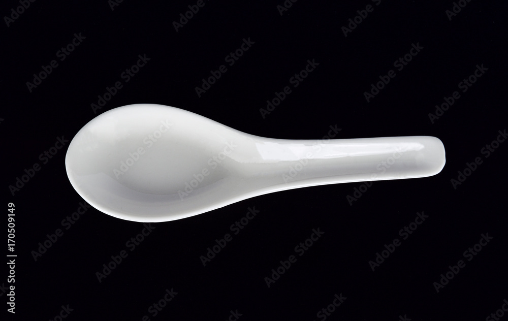 White spoon on black White spoon on black