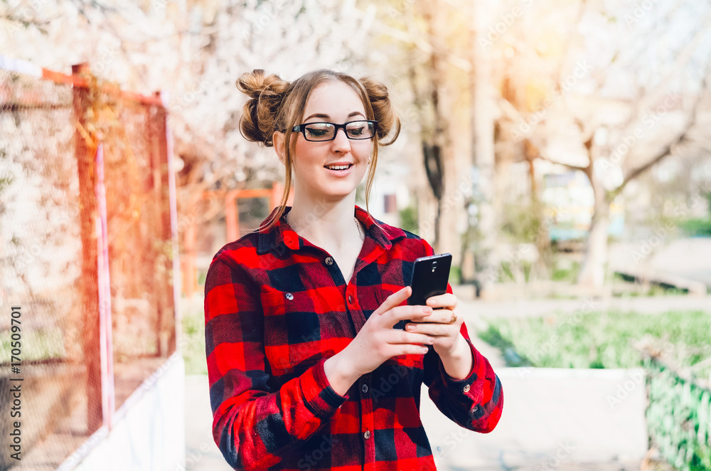 Fototapeta premium Girl in glasses. phone in hand.view of wireless internet
