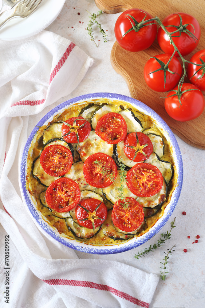 Zucchini and tomatoes gratin with bechamel sauce and cheese
