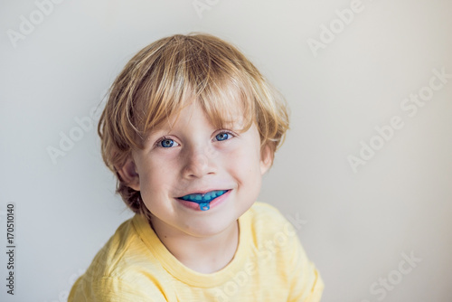 Three-year old boy shows myofunctional trainer to illuminate mouth breathing habit. Helps equalize the growing teeth and correct bite. Corrects the position of the tongue photo