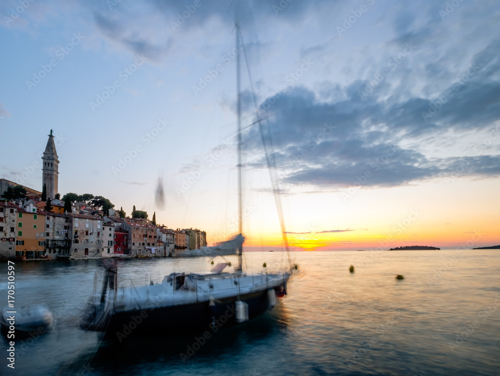 Boats rock themselves to sleep at sunset in Rovinj Croatia