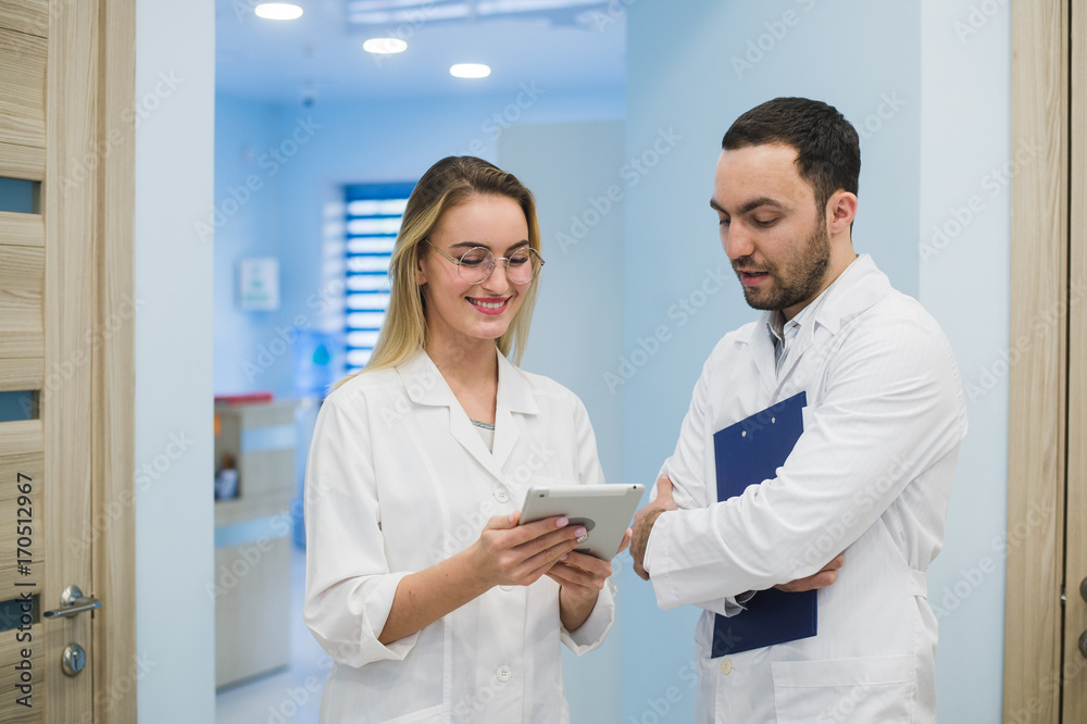 Fototapeta premium Two doctors discussing diagnosis while walking
