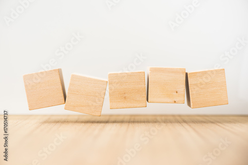 Business concept - Abstract geometric real floating wooden cube on grey background and it's not 3D render, float on wood floor white background for display or montage word.