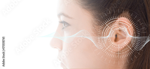 Hearing test showing ear of young woman with sound waves simulation technology