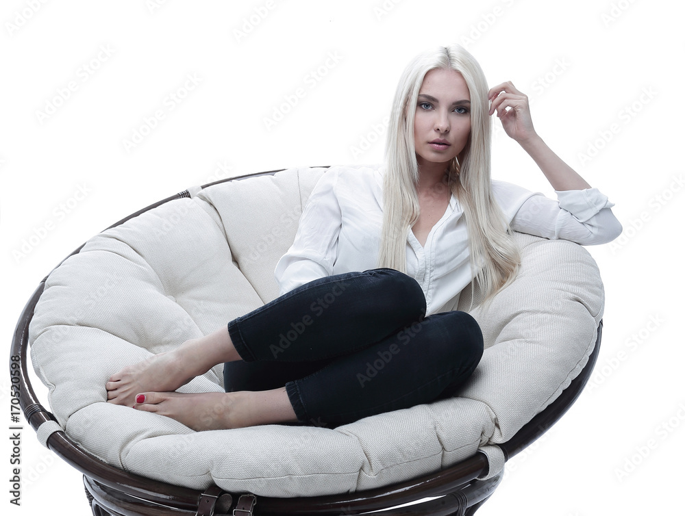 beautiful young woman sitting on the couch in a large comfortabl beautiful young woman sitting on the couch in a large comfortabl