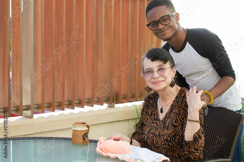 Closeup portrait, relatives sitting and hugging each other, isolated outdoors background