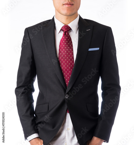 Asia business concept - thoughtful modern office man with dark suit looking at front, stand and think the business plan, isolated on white background.