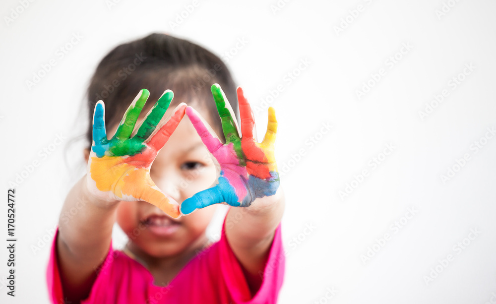 Cute asian child girl with hands painted in colorful paint on white background Cute asian child girl with hands painted in colorful paint on white background