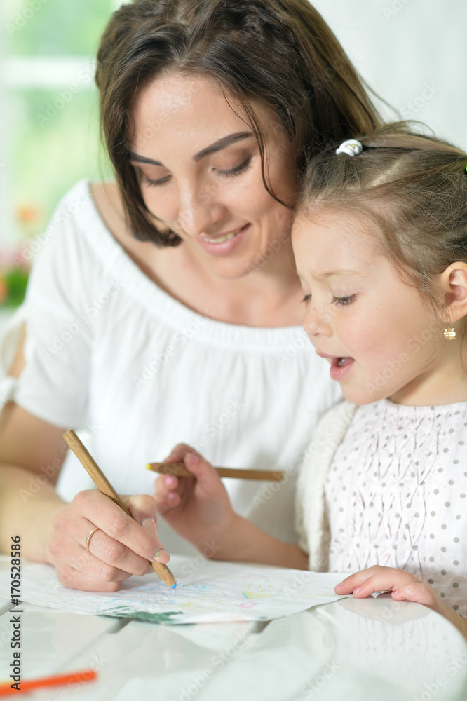 mother and little daughter drawing with pencils mother and little daughter drawing with pencils