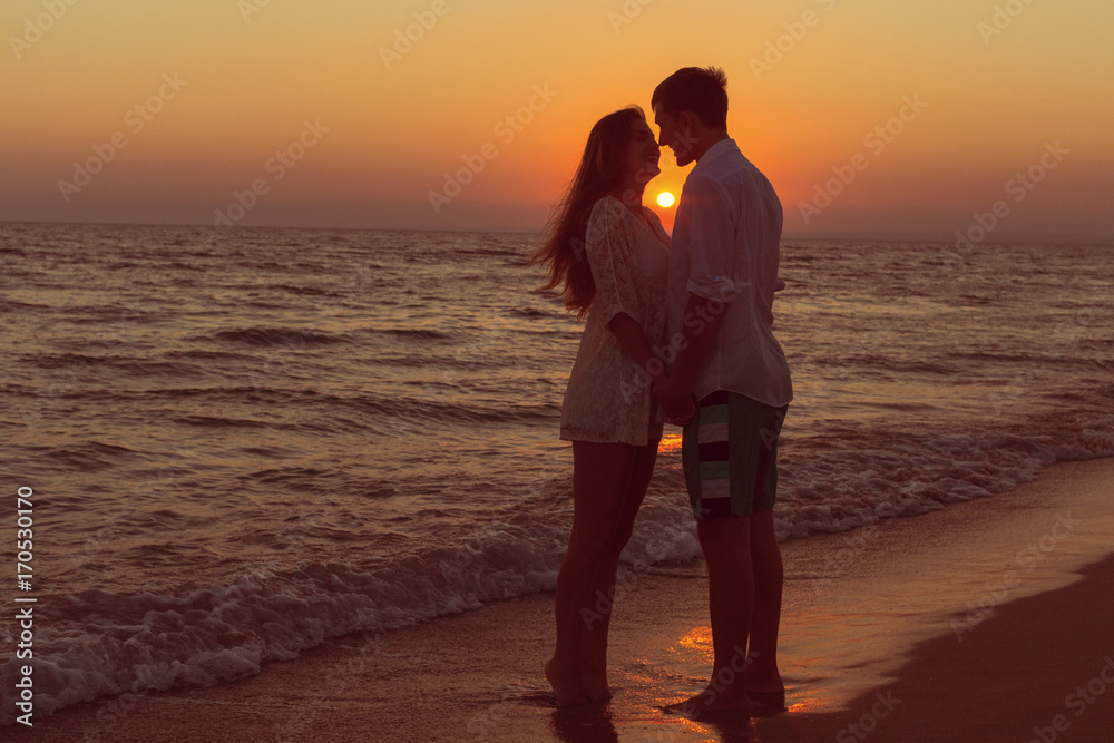 Romantic couple kissing on the beach