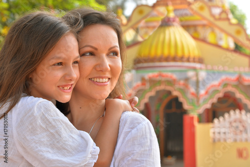 Mother hugging little daughter