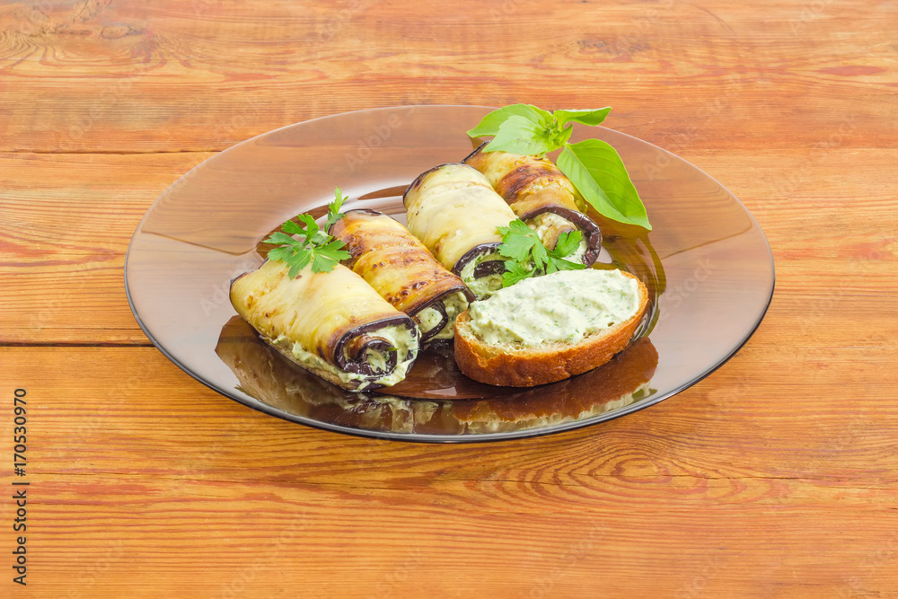 Stuffed eggplant rolls and sandwich on glass dish Stuffed eggplant rolls and sandwich on glass dish