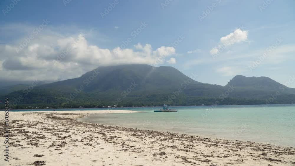Seascape ocean,mountains and beautiful beach paradise. Beach, sea, sand,wave. Tropical beach, blue sky, clouds Philippines Camiguin 4K video Travel concept Seascape ocean,mountains and beautiful beach paradise. Beach, sea, sand,wave. Tropical beach, blue sky, clouds Philippines Camiguin 4K video Travel concept