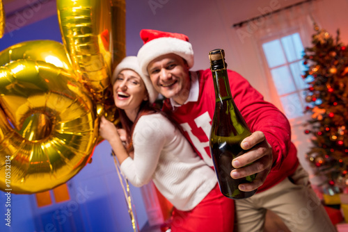 couple with balloons and champagne bottle