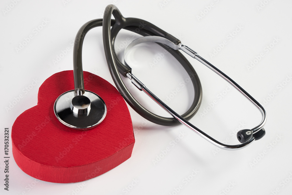 Red heart and a medical stethoscope isolated on white Red heart and a medical stethoscope isolated on white