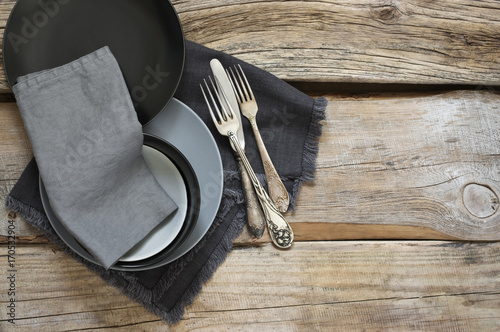 Grey kitchen utensils on rough distressed wooden table