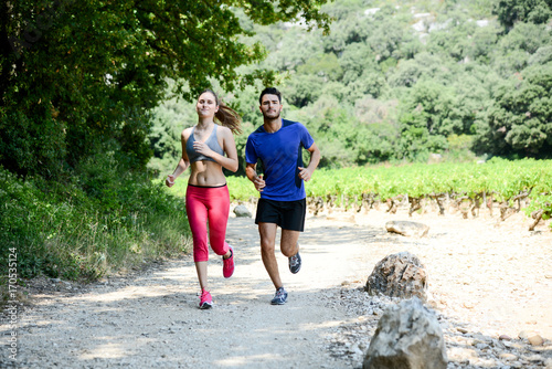 beautiful young couple running sport fitness exercising together outdoor countryside forest © W PRODUCTION