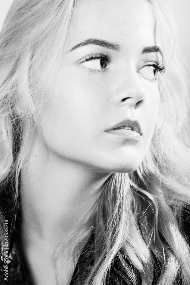 Fototapeta premium beautiful young blond female portrait on white background, monochrome